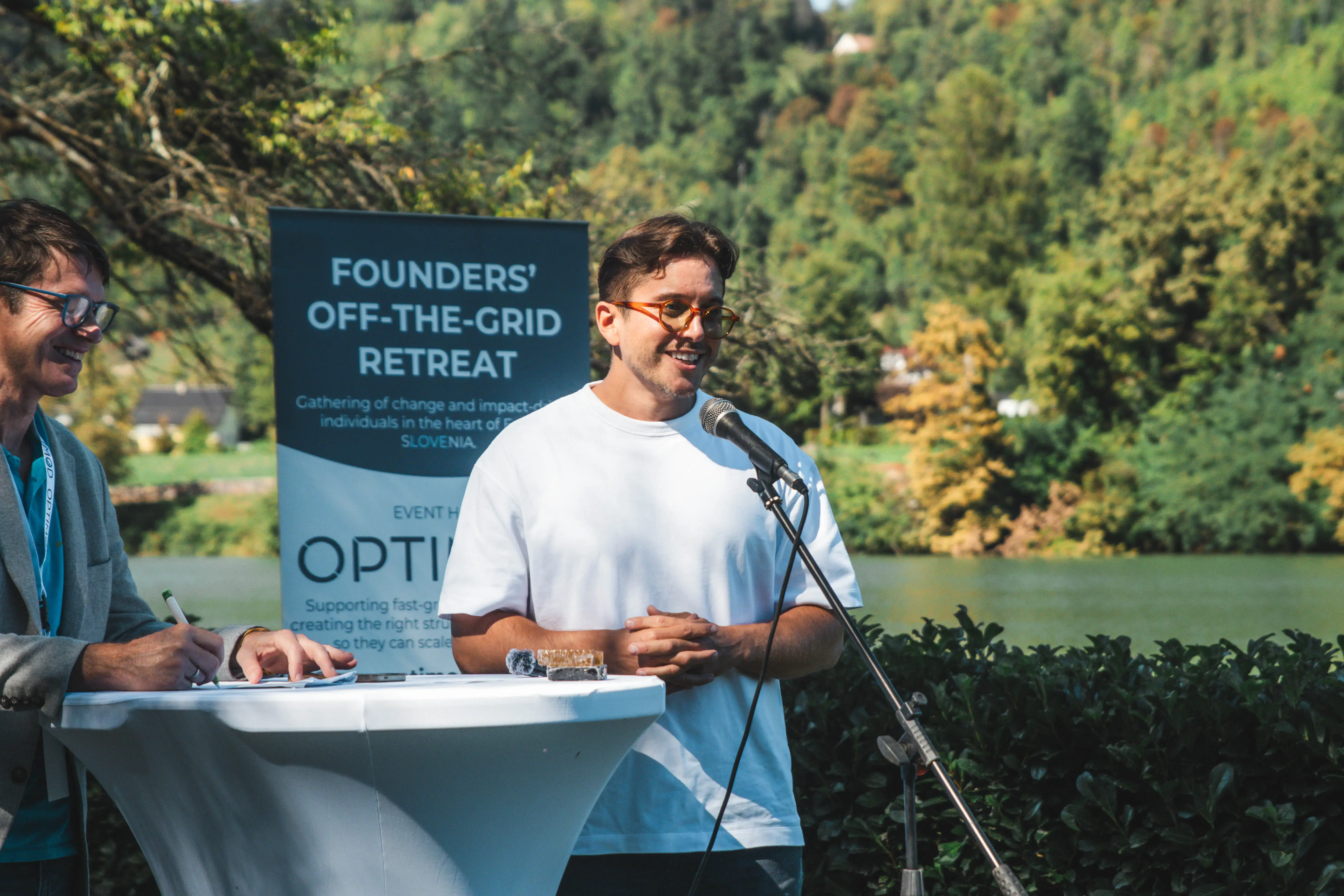 photo of dj's back working while also capturing the crowd vibing and the glowing atmosphere