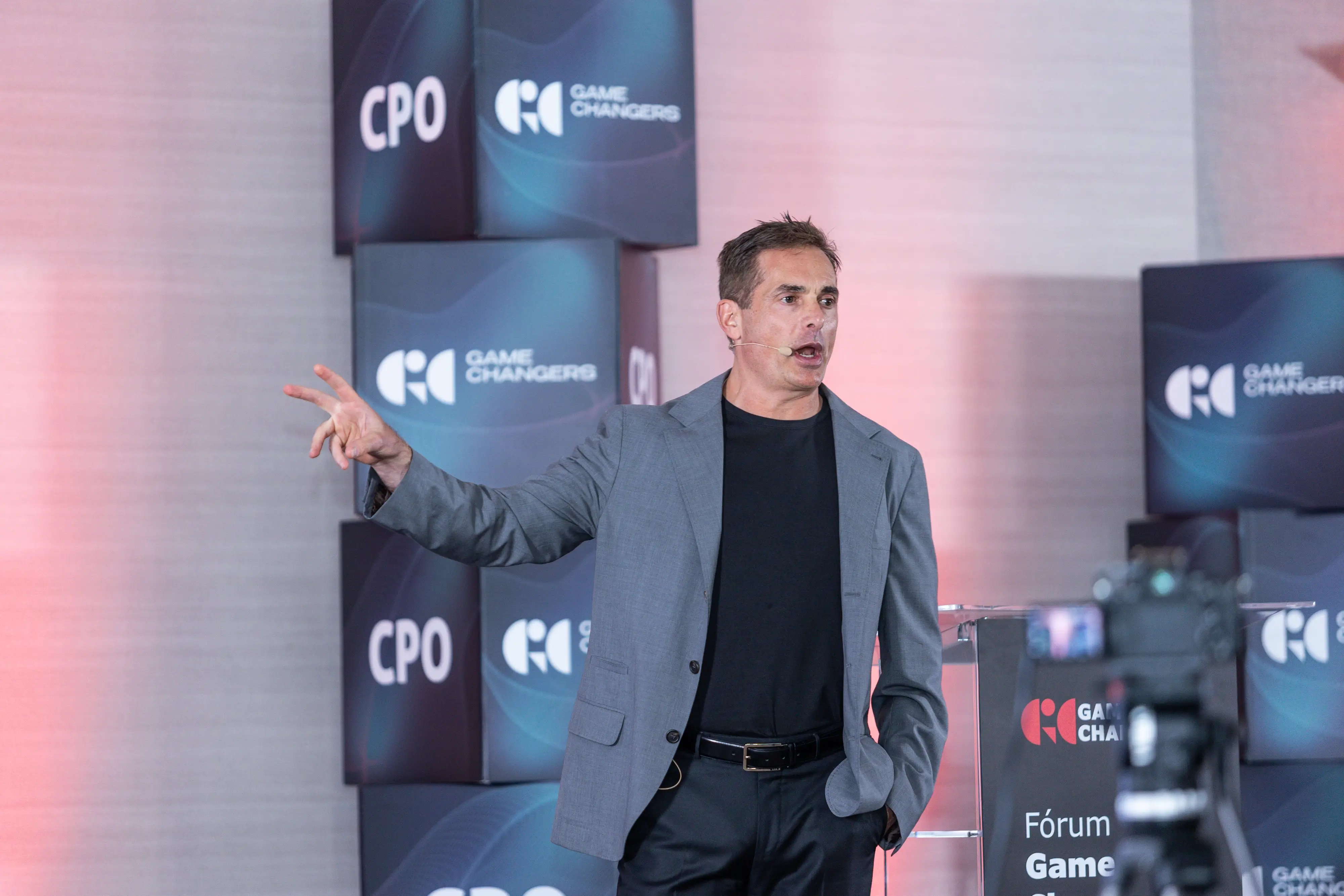 photo of dj's back working while also capturing the crowd vibing and the glowing atmosphere